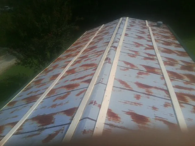 Rusted metal roof panels with new wood purlins before replacement — Storm Damage Roof Repair in Cartersville by Roofing Brothers