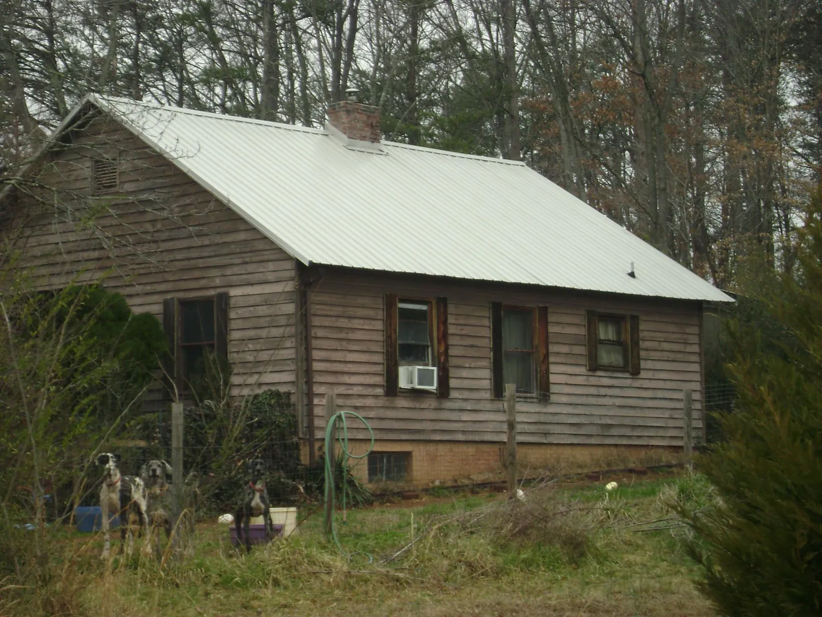 White metal roof on an old wood sided farmhouse, from a Metal Roof Installation job in Cartersville